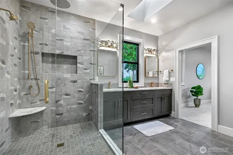 a bathroom with a granite countertop sink mirror and shower