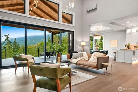 a living room with furniture and floor to ceiling windows