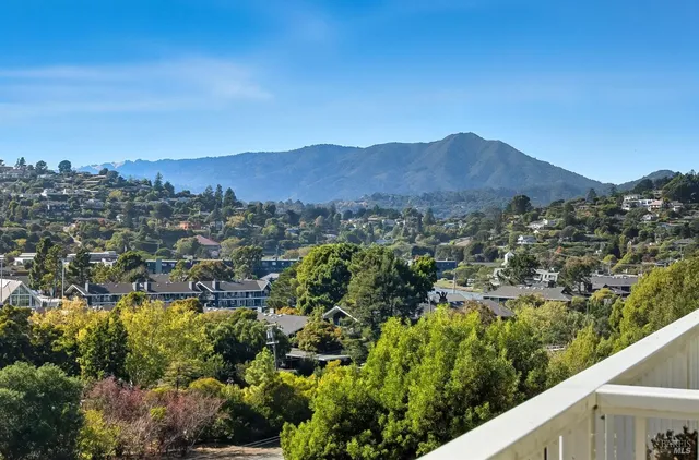 a view of city and mountain from a balcony