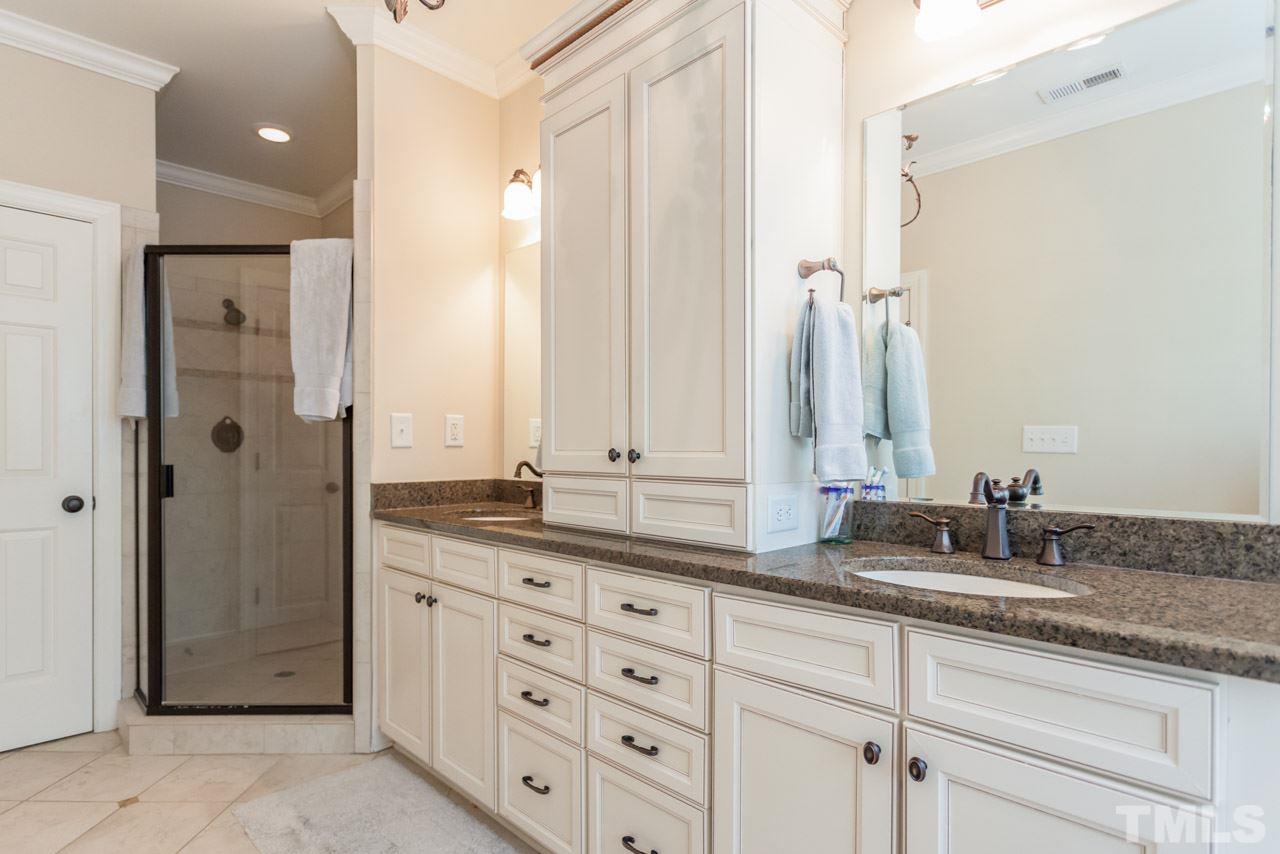 2425 Coley Forest Place Raleigh, NC 27612 - Photo 13 of 24 a bathroom with a granite countertop sink and a mirror