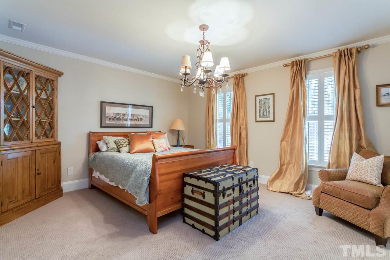2425 Coley Forest Place Raleigh, NC 27612 - Photo 14 of 24 a bedroom with a bed a couch and dresser