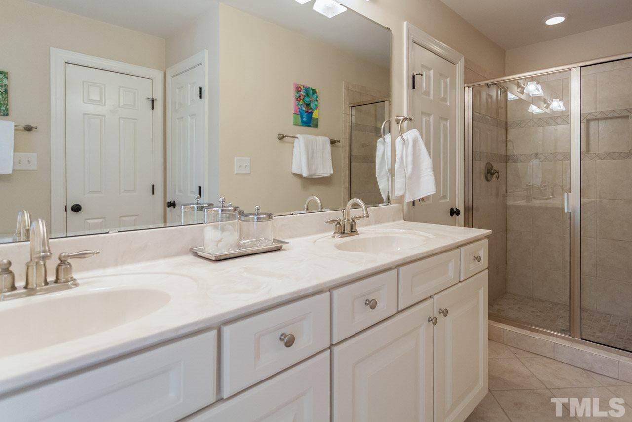 2425 Coley Forest Place Raleigh, NC 27612 - Photo 15 of 24 a bathroom with double sink and a mirror