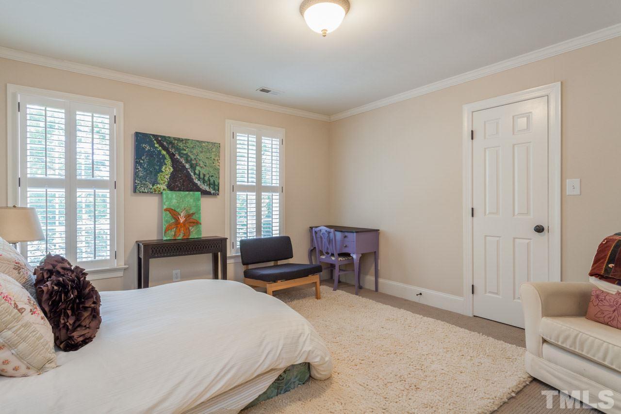 2425 Coley Forest Place Raleigh, NC 27612 - Photo 16 of 24 a bedroom with a bed and a couch