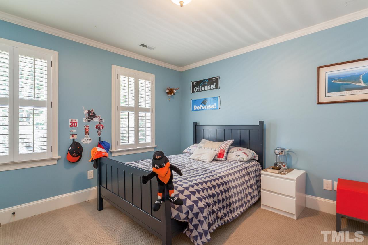 2425 Coley Forest Place Raleigh, NC 27612 - Photo 17 of 24 a bedroom with bed and a window