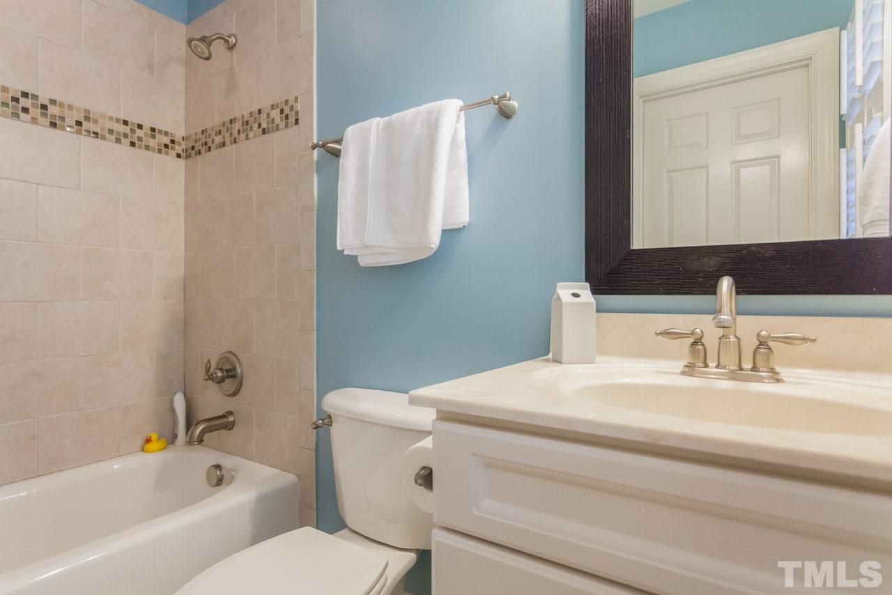 2425 Coley Forest Place Raleigh, NC 27612 - Photo 18 of 24 a bathroom with a sink toilet and shower
