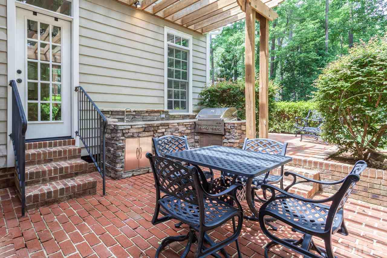 2425 Coley Forest Place Raleigh, NC 27612 - Photo 23 of 24 a patio with table and chairs