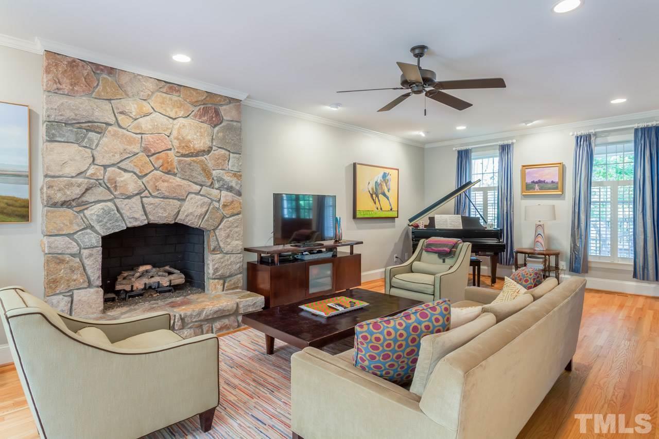2425 Coley Forest Place Raleigh, NC 27612 - Photo 6 of 24 a living room with furniture and a fireplace