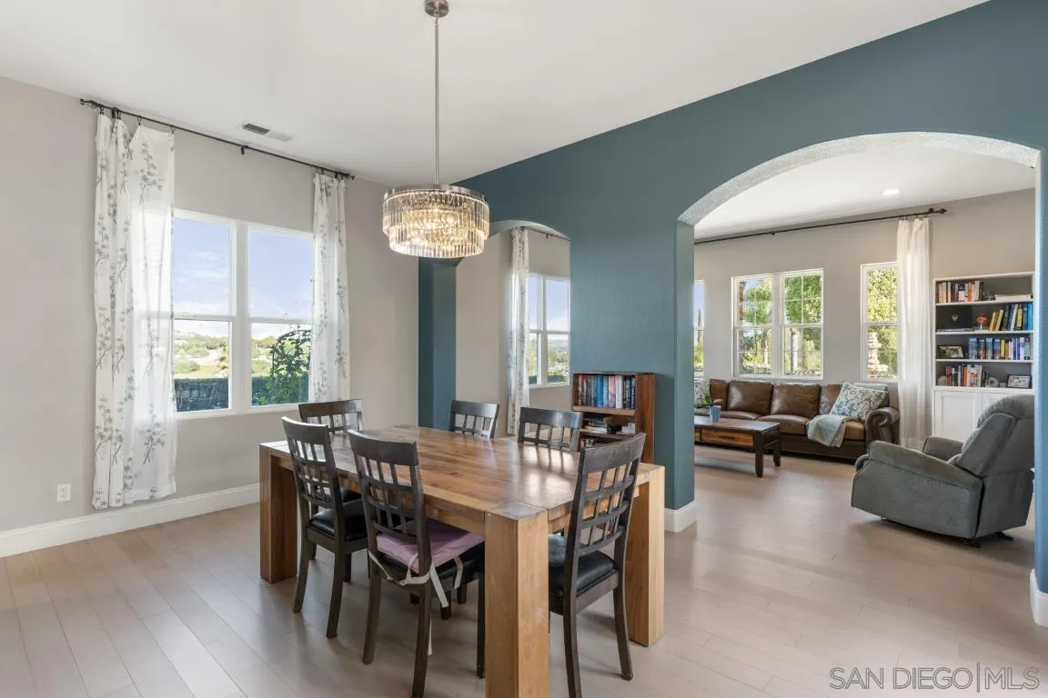 310 Highland Oaks Court Fallbrook, CA 92028 - Photo 15 of 52 a view of a dining room with furniture window and wooden floor