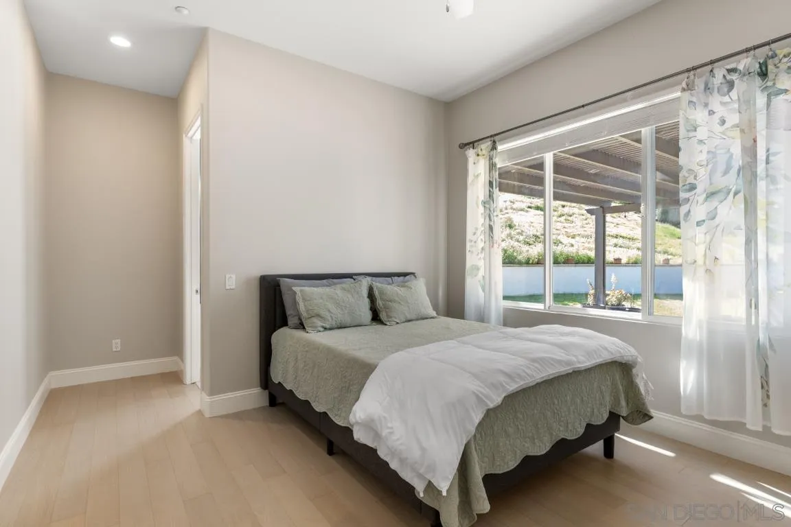310 Highland Oaks Court Fallbrook, CA 92028 - Photo 21 of 52 a large bed sitting in a bedroom next to a window