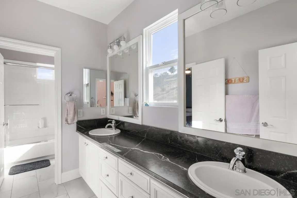 310 Highland Oaks Court Fallbrook, CA 92028 - Photo 24 of 52 a bathroom with a sink and a mirror