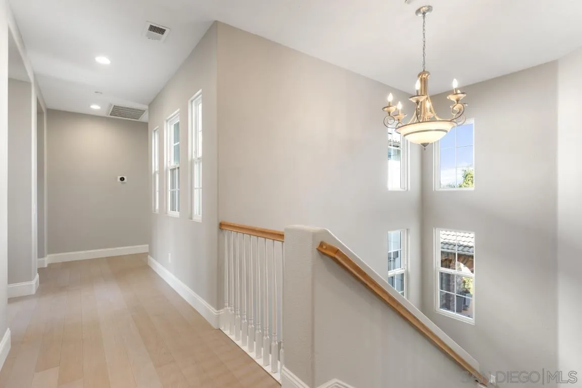 310 Highland Oaks Court Fallbrook, CA 92028 - Photo 26 of 52 a view of a hallway with windows and chandelier