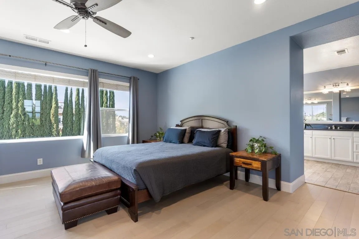 310 Highland Oaks Court Fallbrook, CA 92028 - Photo 27 of 52 a bedroom with a bed and a chandelier