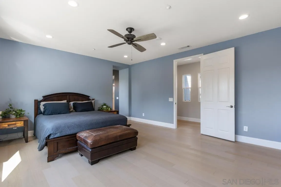 310 Highland Oaks Court Fallbrook, CA 92028 - Photo 28 of 52 a bedroom with a bed and a chandelier