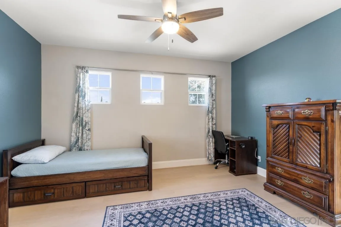 310 Highland Oaks Court Fallbrook, CA 92028 - Photo 33 of 52 a bedroom with a bed and wooden floor