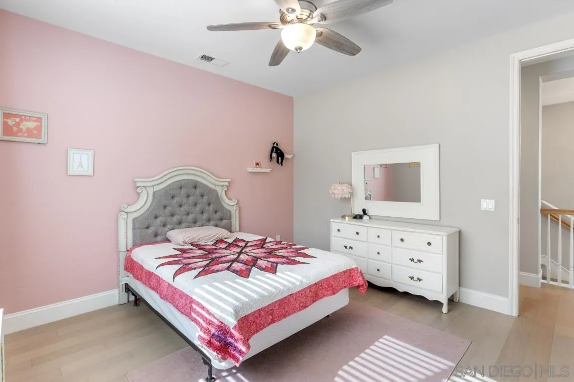 310 Highland Oaks Court Fallbrook, CA 92028 - Photo 35 of 52 a bedroom with a bed and a chandelier
