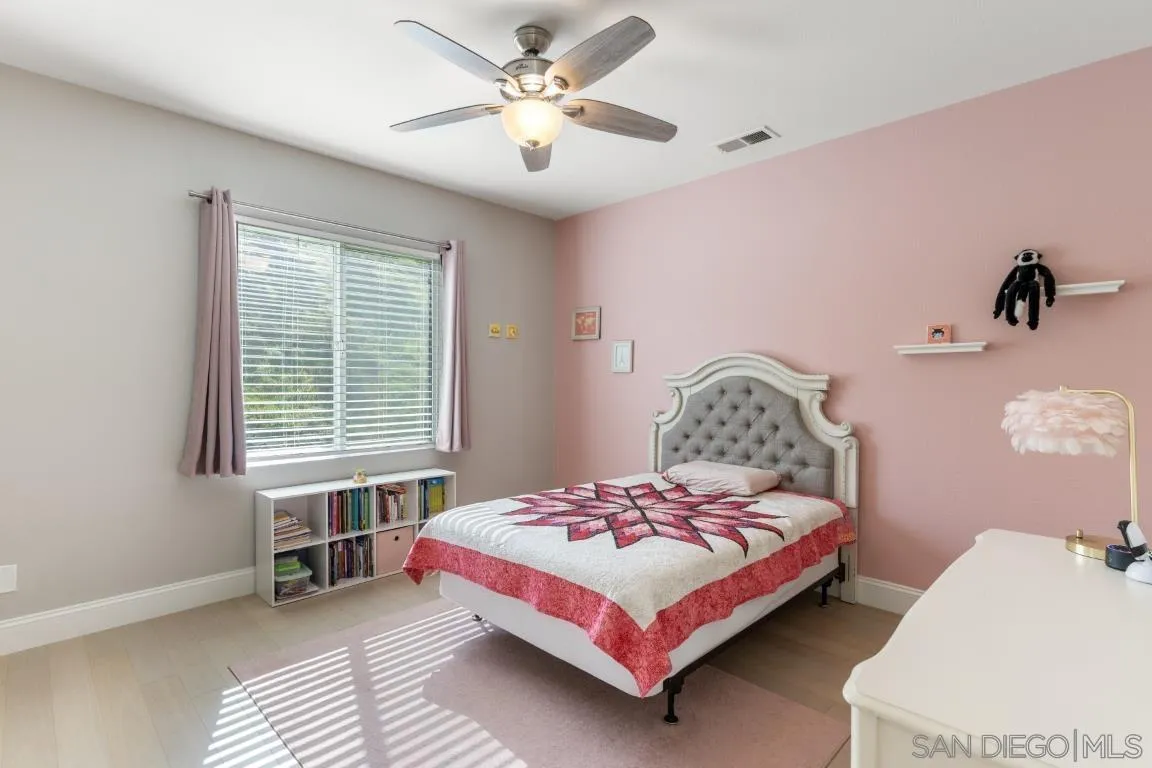 310 Highland Oaks Court Fallbrook, CA 92028 - Photo 36 of 52 a bedroom with a bed and a chandelier