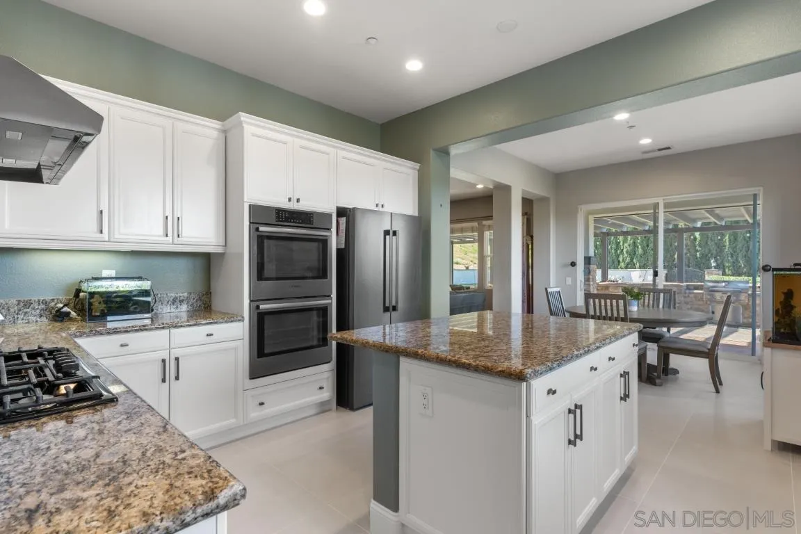 310 Highland Oaks Court Fallbrook, CA 92028 - Photo 10 of 52 a kitchen with granite countertop a sink stove and refrigerator