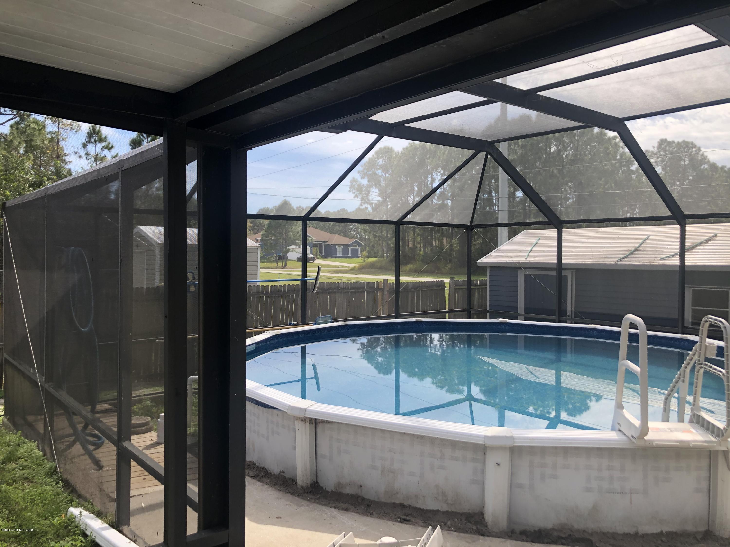 242 Sarah Road Southwest Palm Bay, FL 32908 - Photo 22 of 27 a view of outdoor space with swimming pool and furniture