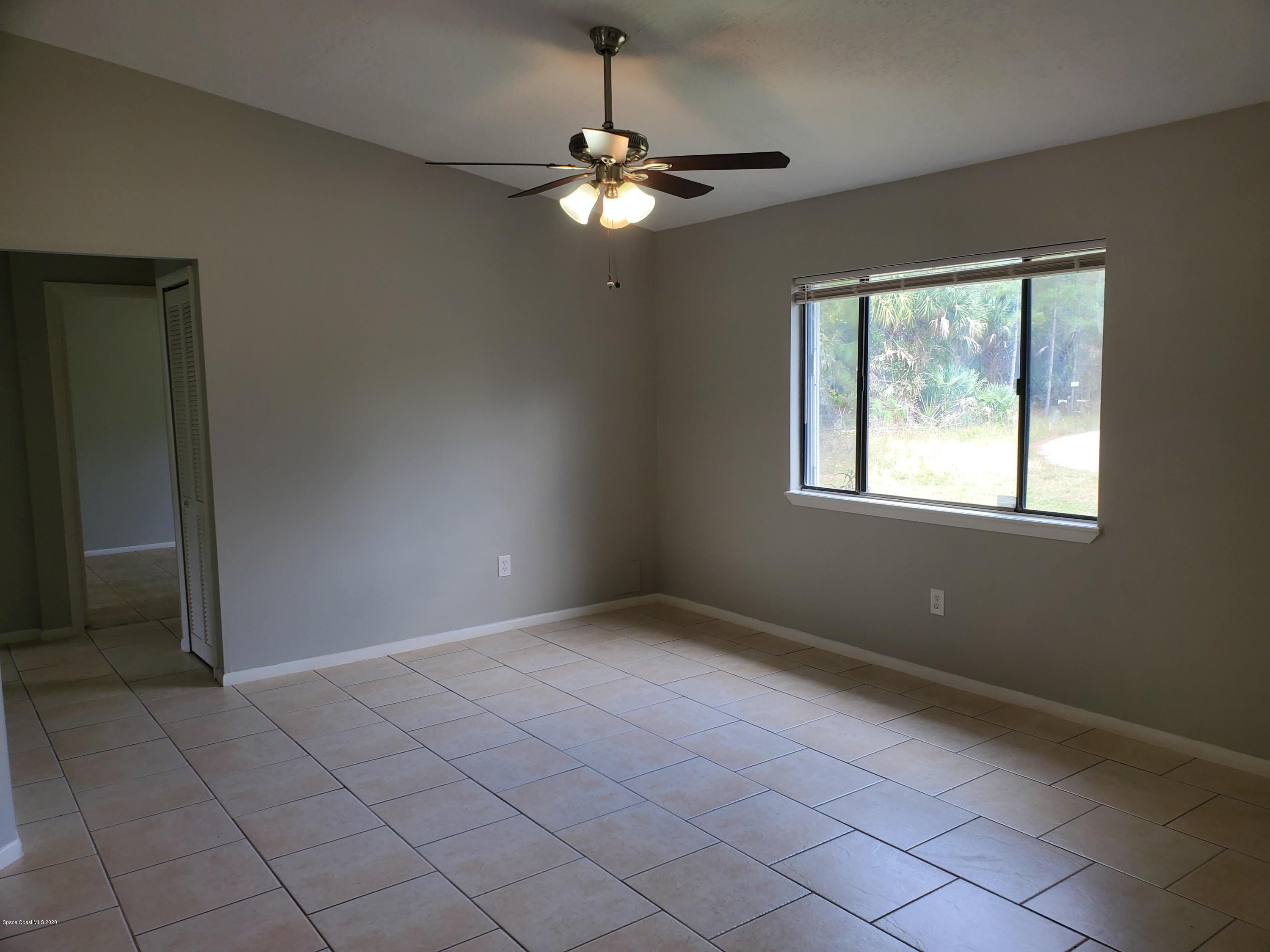 242 Sarah Road Southwest Palm Bay, FL 32908 - Photo 8 of 27 a view of an empty room with a window