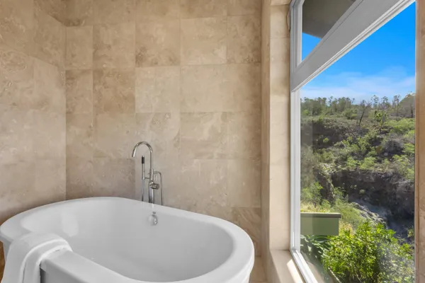a bathroom with a tub and shower