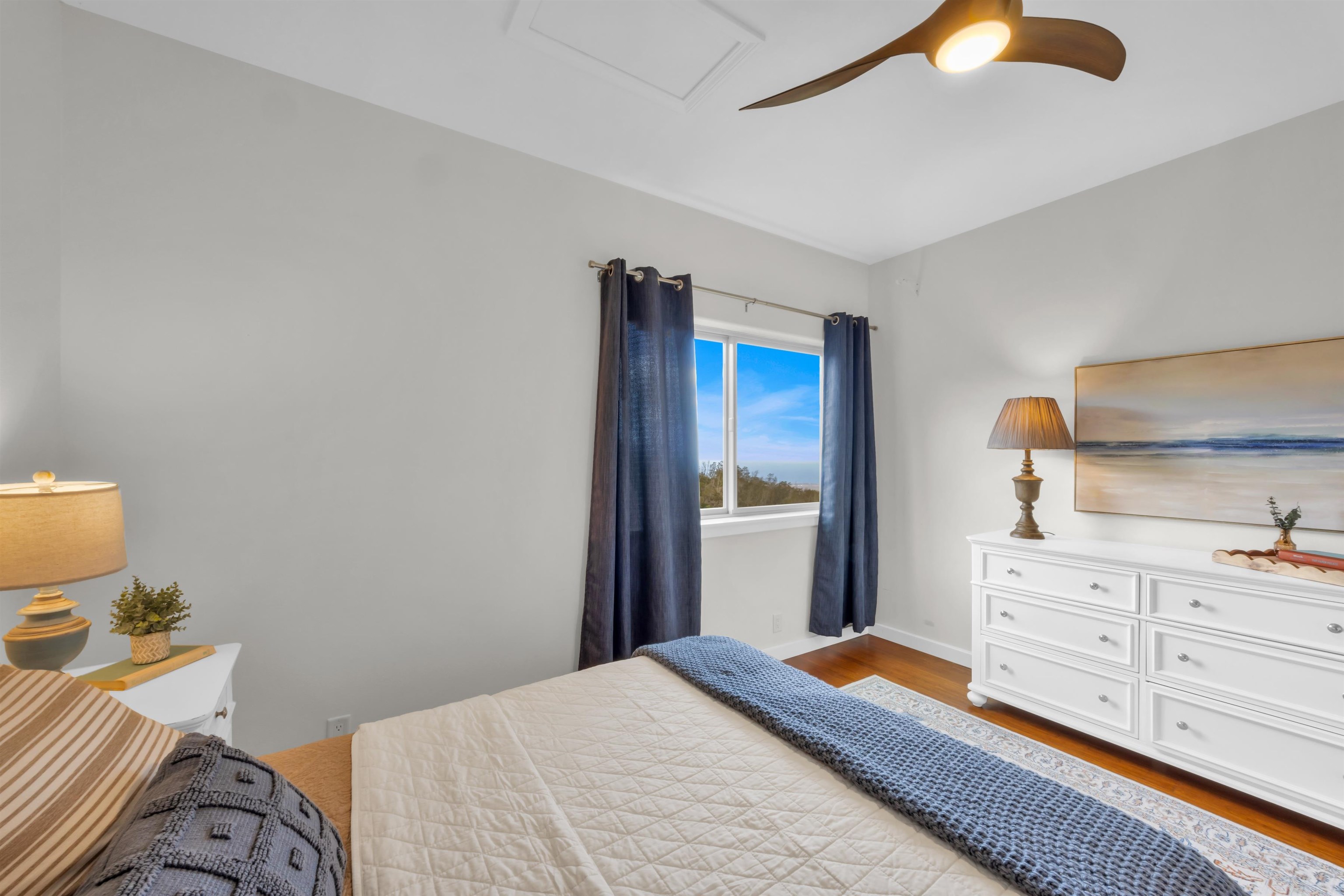 183 Kulamanu Circle Kula, HI 96790 - Photo 32 of 42 a bedroom with a bed and a lamp on dresser