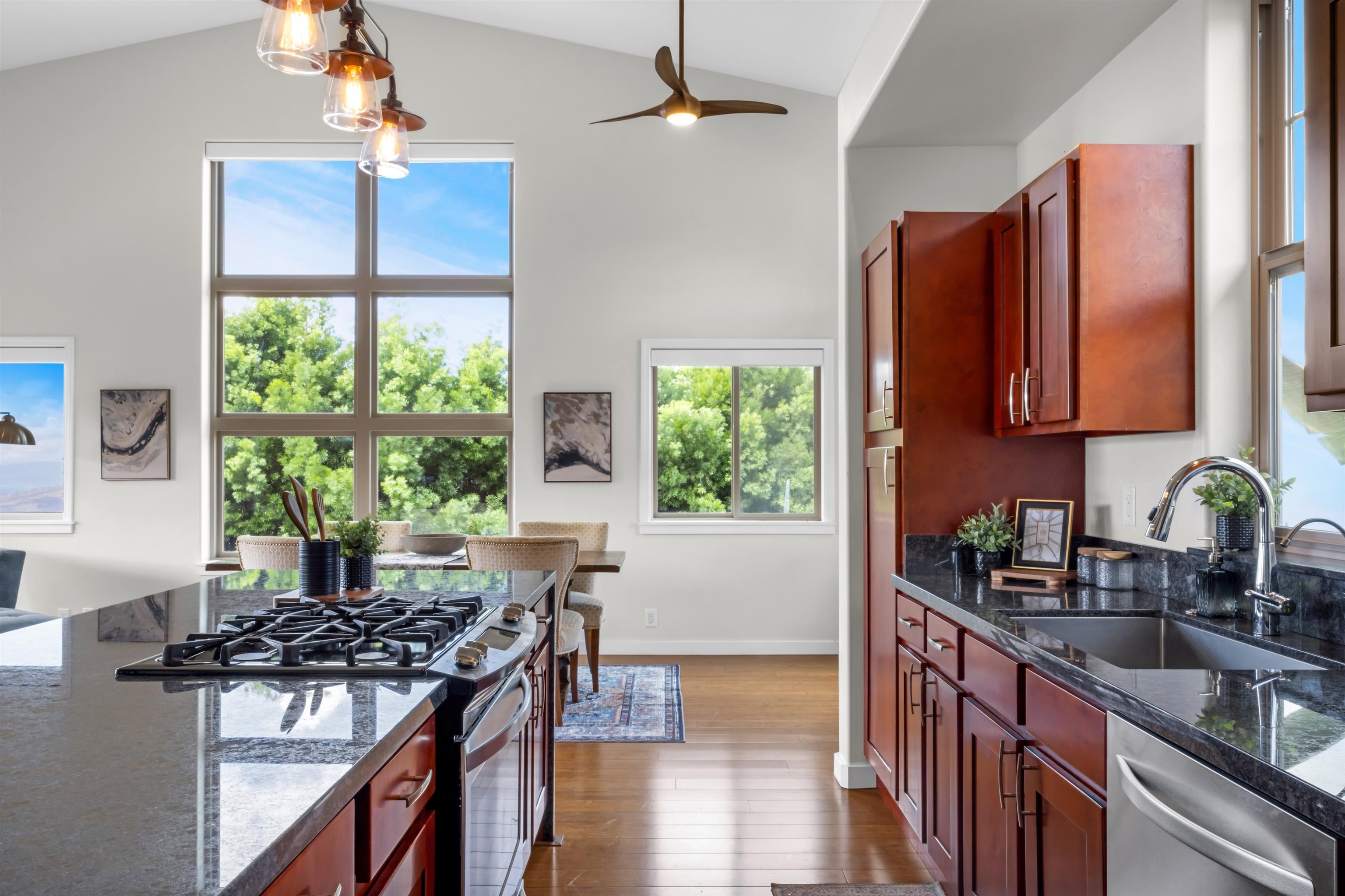 183 Kulamanu Circle Kula, HI 96790 - Photo 9 of 42 a kitchen with stainless steel appliances granite countertop a stove a sink dishwasher and a refrigerator with wooden floor