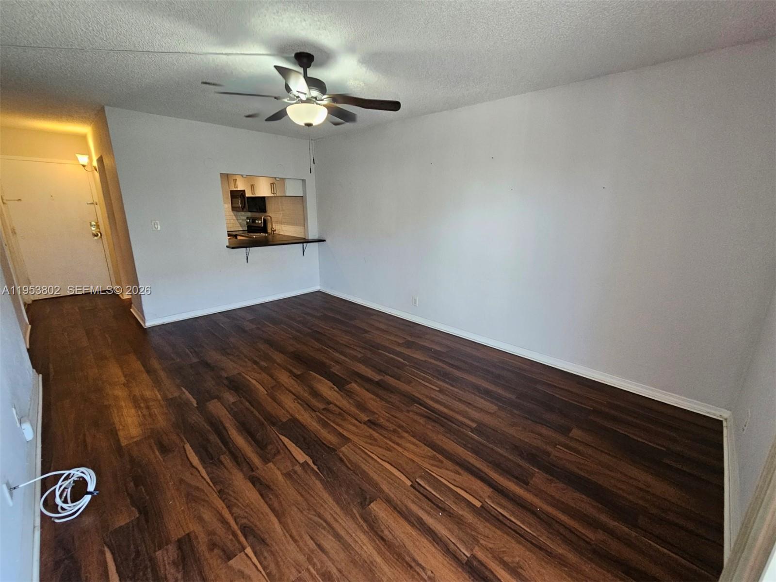 4550 Northwest 9th Street, Unit 315E Miami, FL 33126 - Photo 4 of 15 a view of a hallway with wooden floor and a ceiling fan
