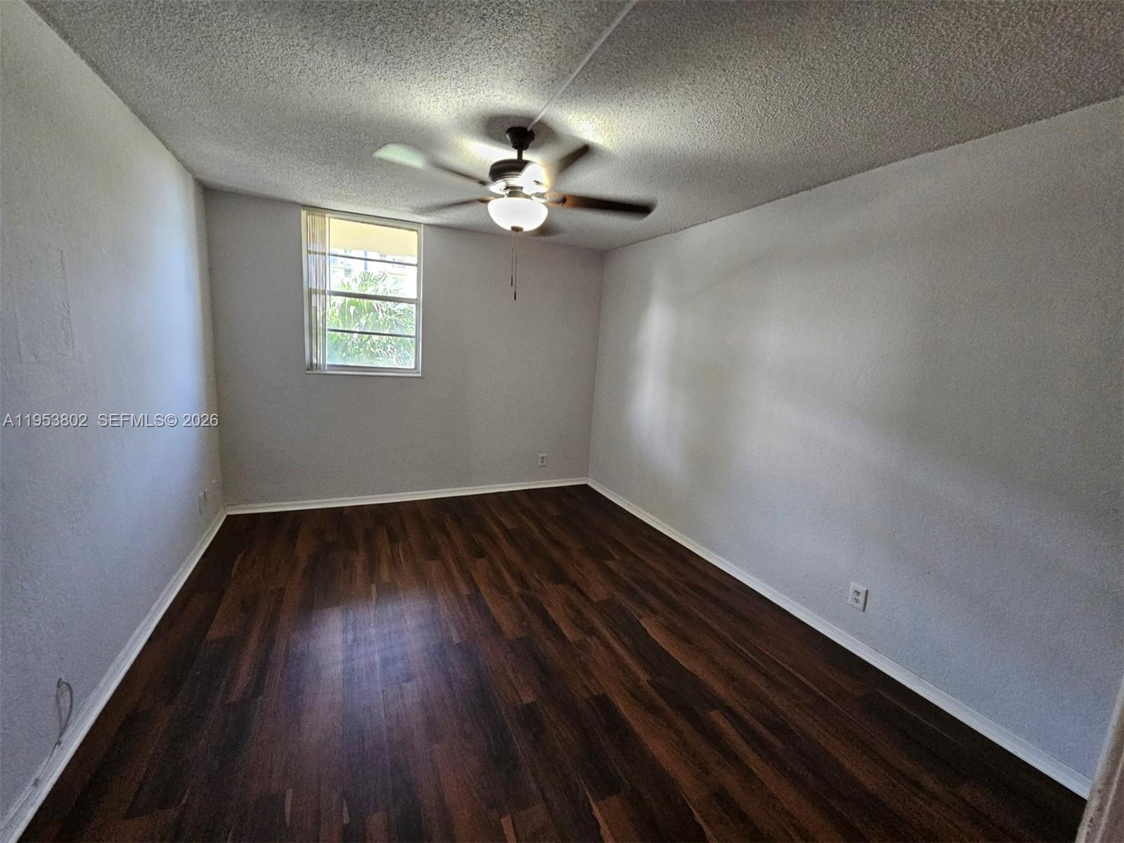 4550 Northwest 9th Street, Unit 315E Miami, FL 33126 - Photo 5 of 15 wooden floor in an empty room with a window
