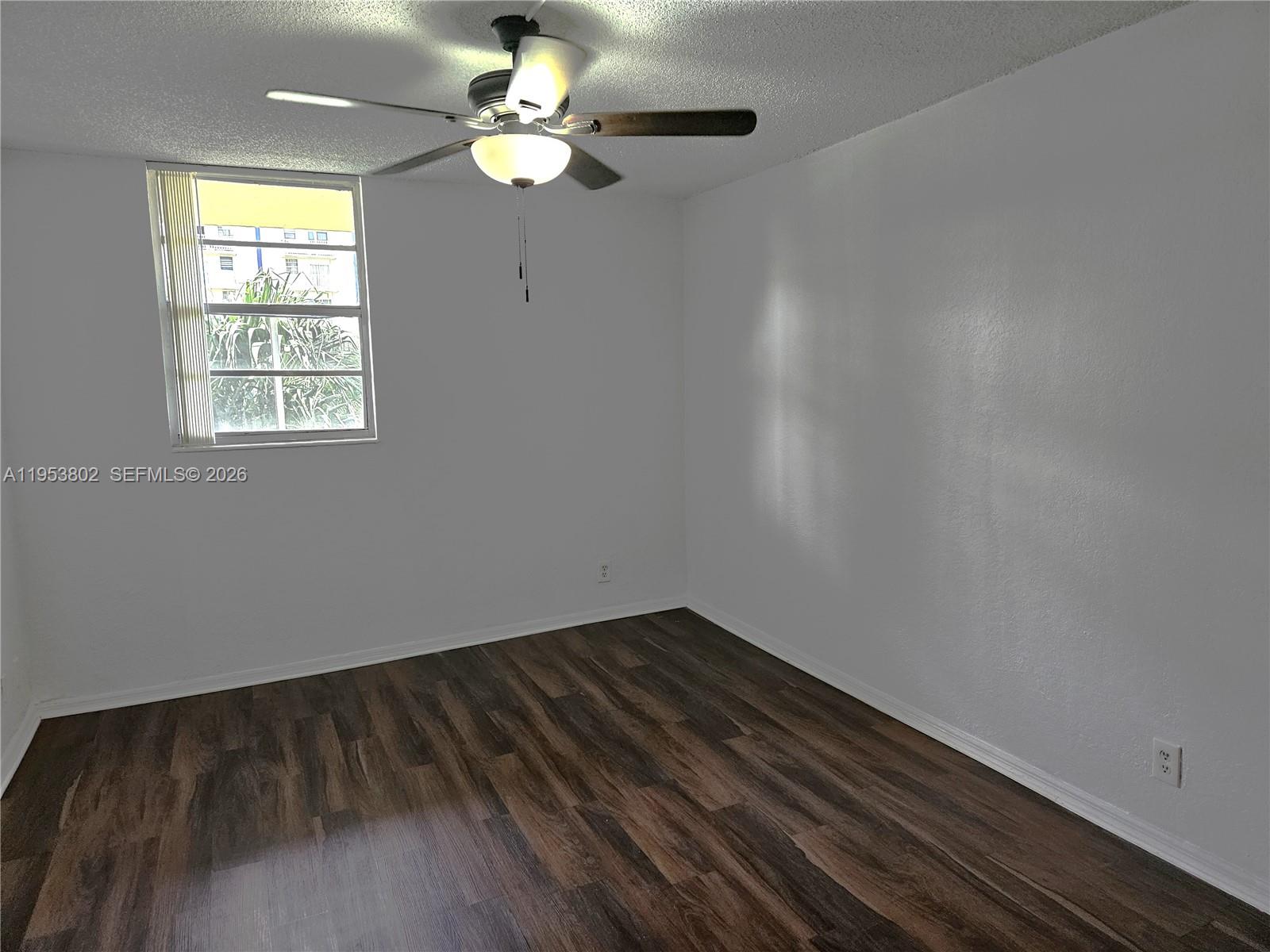4550 Northwest 9th Street, Unit 315E Miami, FL 33126 - Photo 7 of 15 wooden floor in an empty room with a window