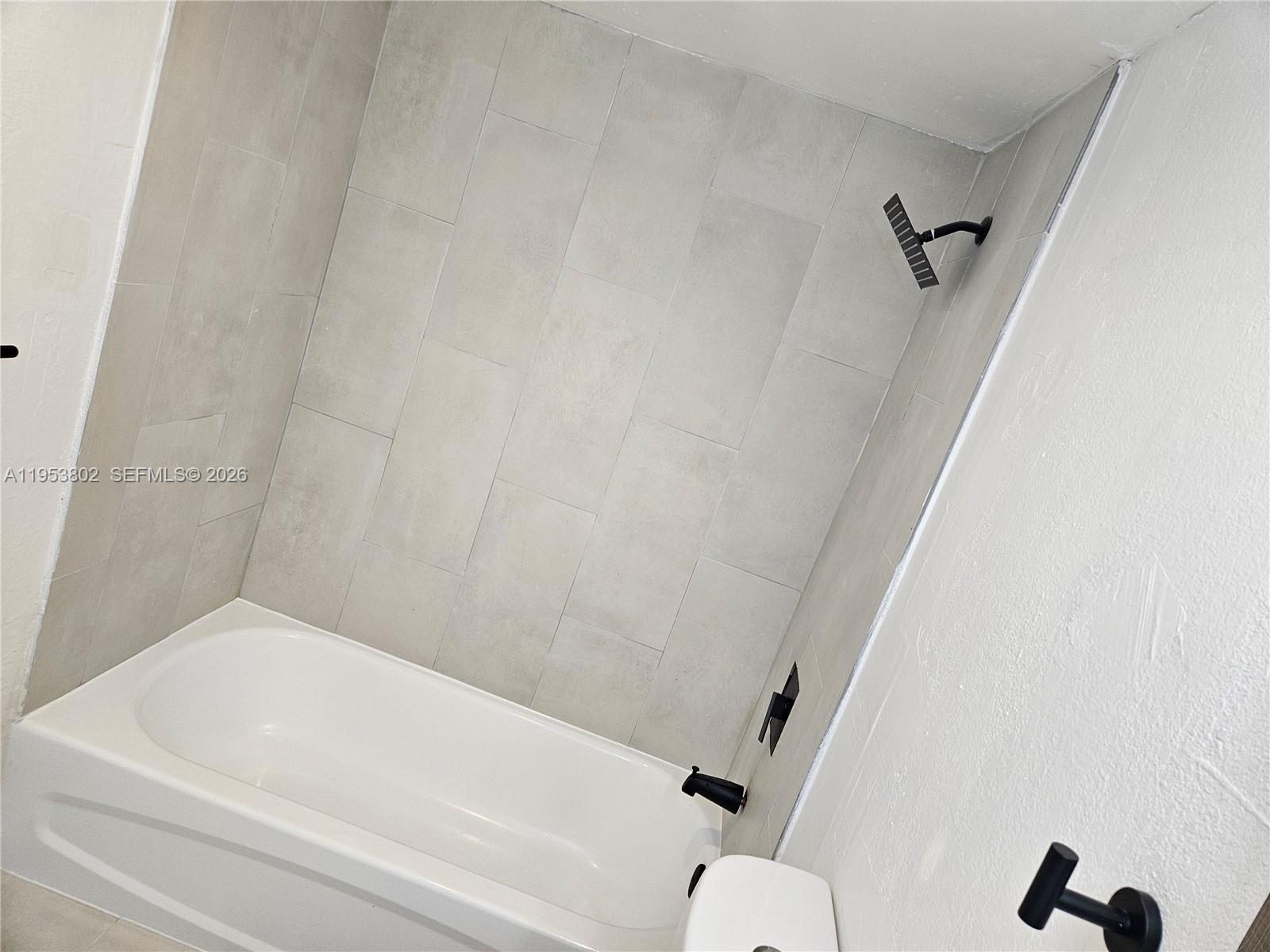 4550 Northwest 9th Street, Unit 315E Miami, FL 33126 - Photo 9 of 15 a bathroom with a bathtub and a toilet