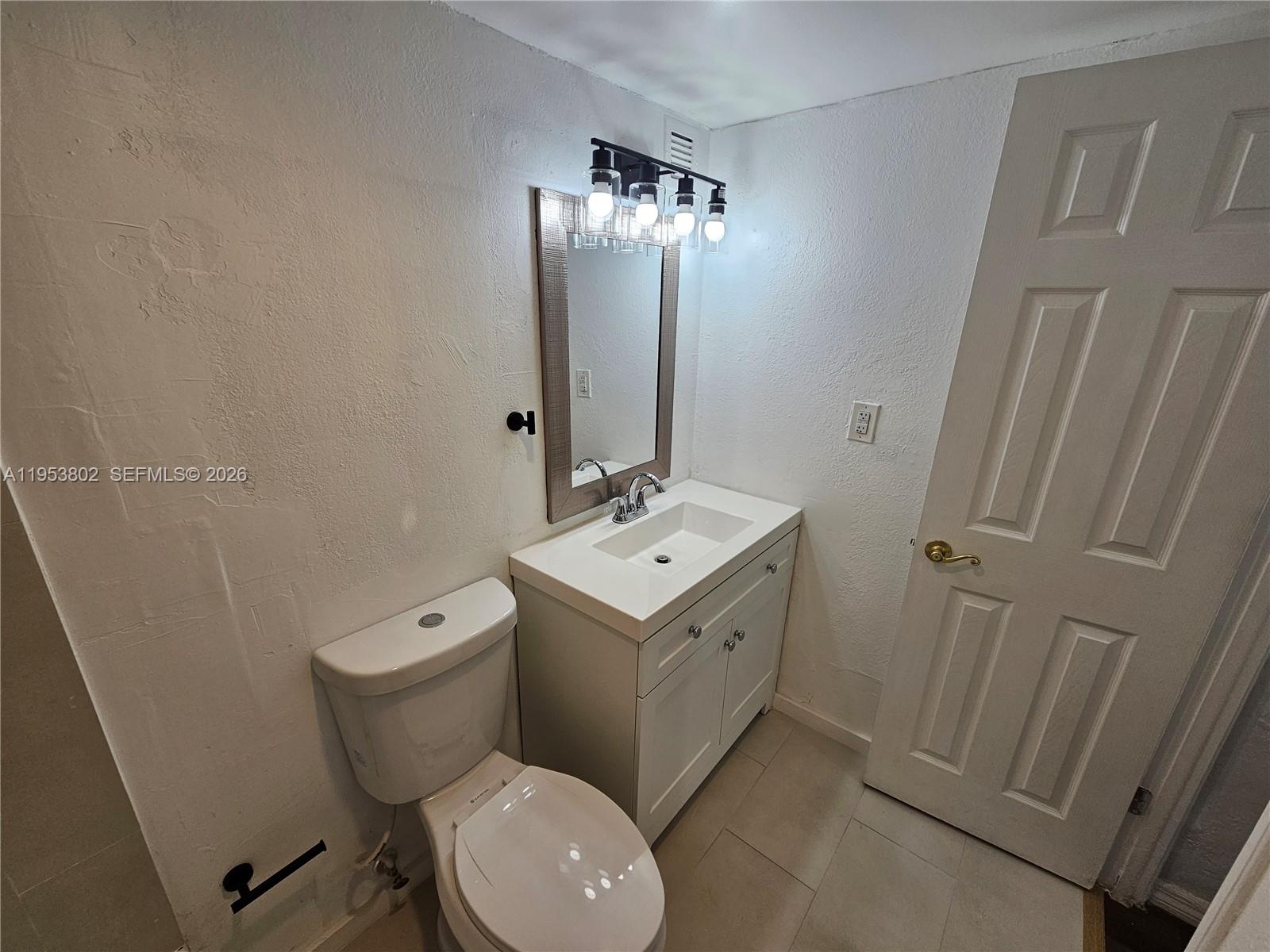 4550 Northwest 9th Street, Unit 315E Miami, FL 33126 - Photo 10 of 15 a bathroom with a sink toilet and shower