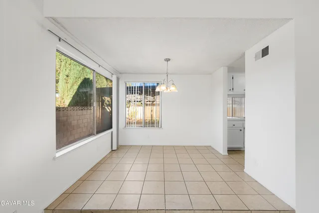 a room with a chandelier and fireplace
