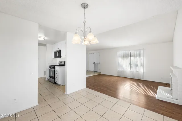 a kitchen with granite countertop a sink and a stove