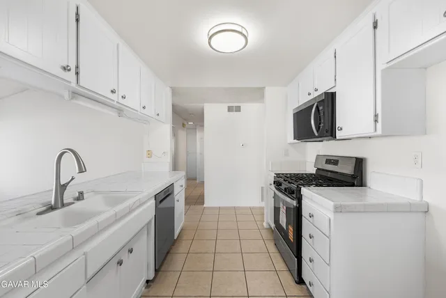 a kitchen with a stove and a microwave