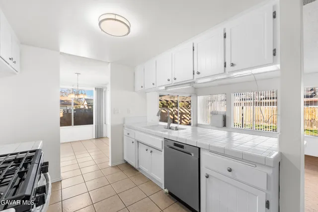 a view of kitchen with refrigerator and wooden floor