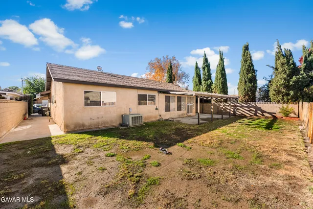 a view of a patio with table and chairs and potted plants