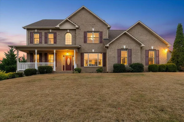 a front view of a house with a yard and garage