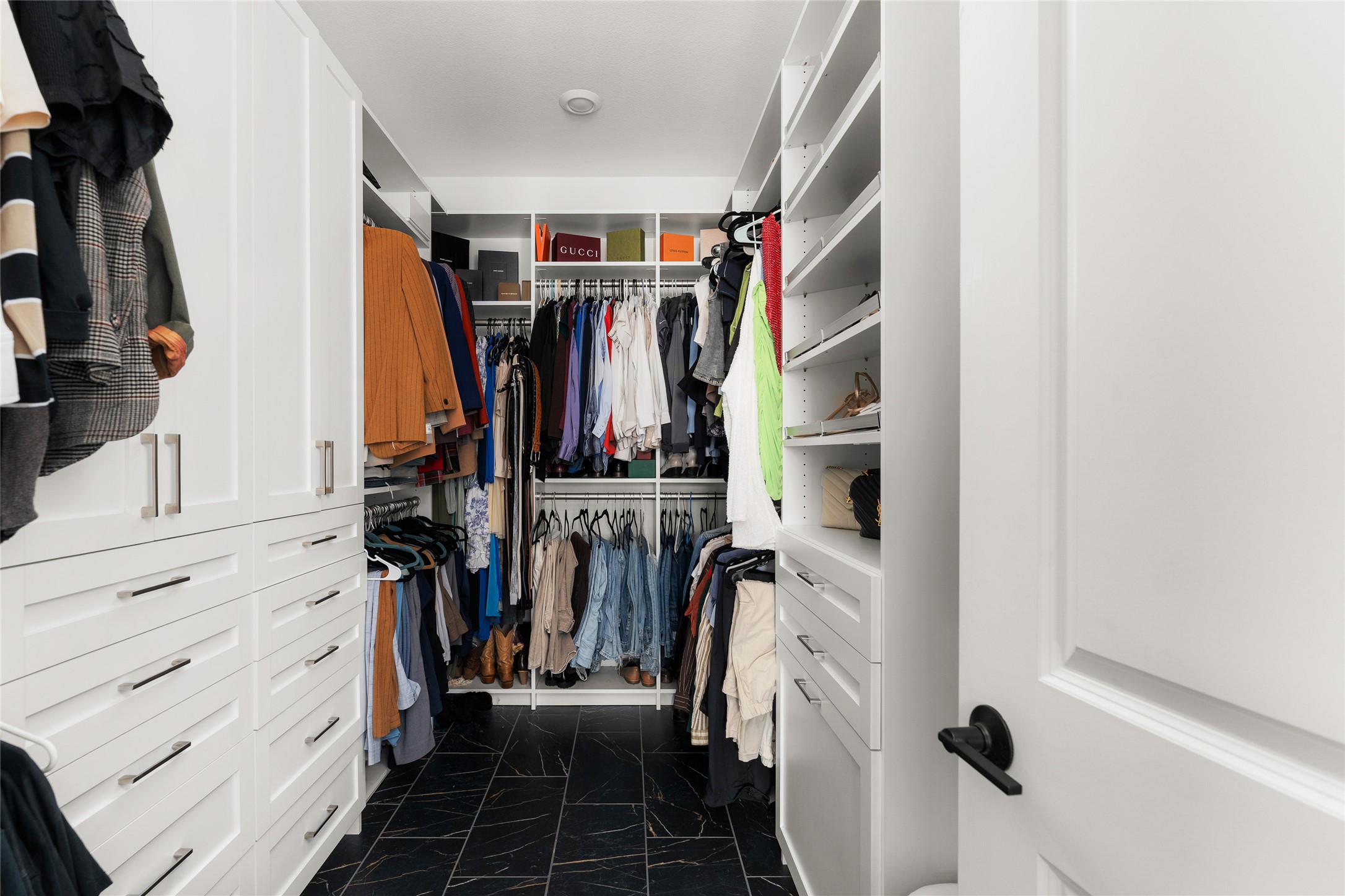 7917 Edmondson Bend Austin, TX 78744 - Photo 11 of 24 Custom closet system featuring extensive built-in cabinetry, multiple hanging rods, and open shelving