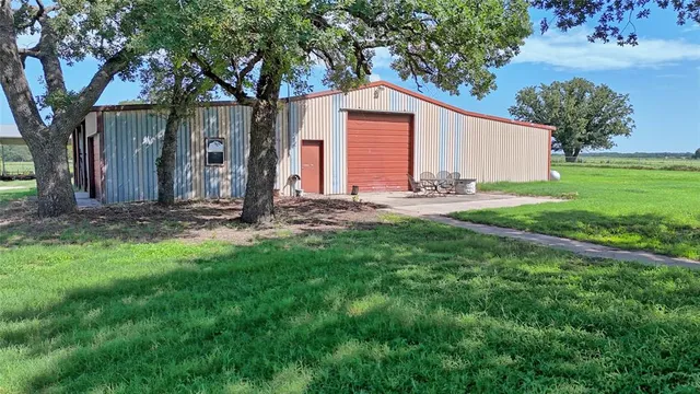 a view of a house with yard and tree s