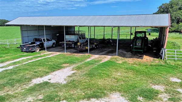 a view of a house with backyard porch and sitting area