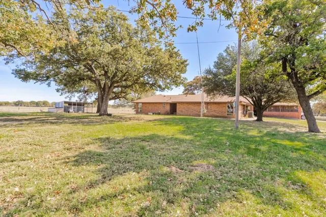 a house view with swimming pool and garden