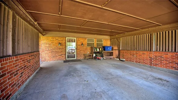 a view of a patio with table and chairs