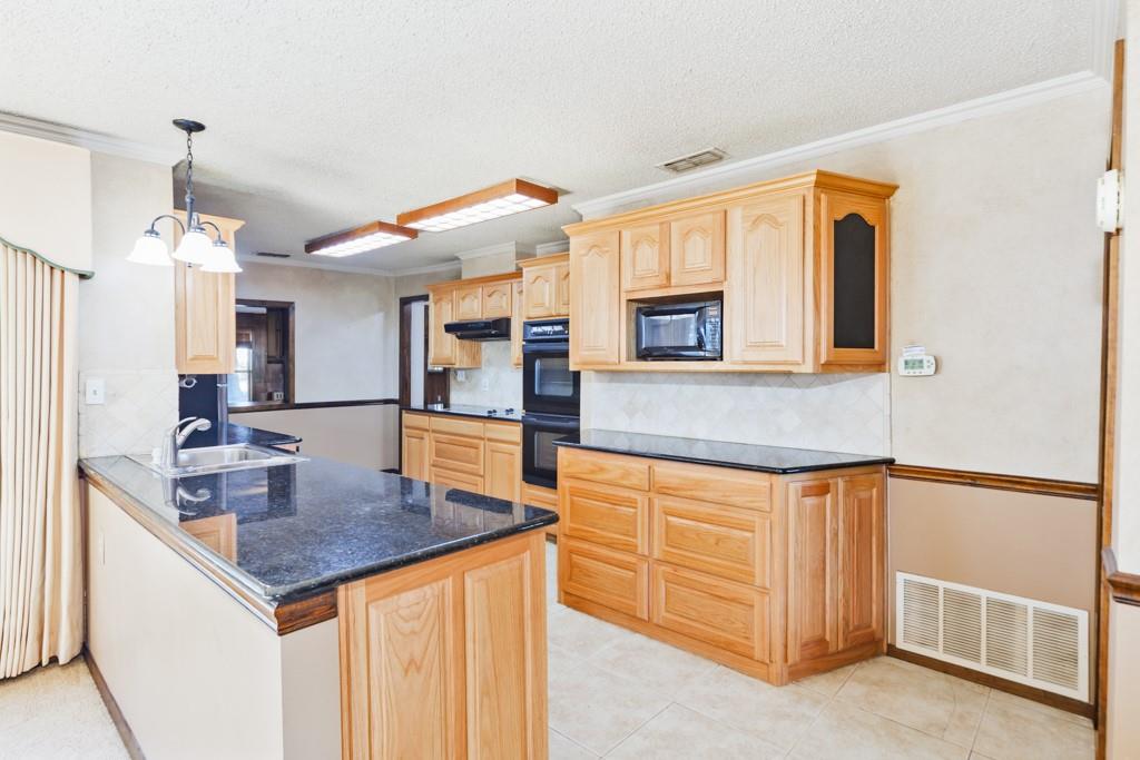 8752 Fm 1749 Sunset, TX 76270 - Photo 25 of 40 a kitchen with stainless steel appliances granite countertop a sink and a refrigerator