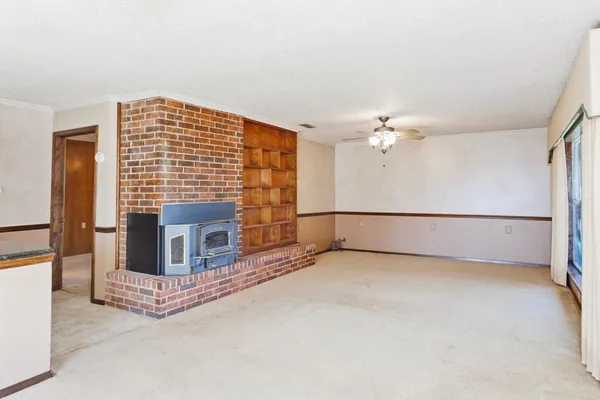 a view of an empty room with a fireplace