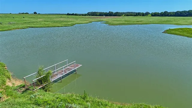 a view of a lake with a yard and lake view