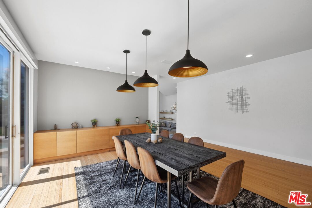23400 West Moon Shadows Drive Malibu, CA 90265 - Photo 14 of 31 a dining room with a table and chairs