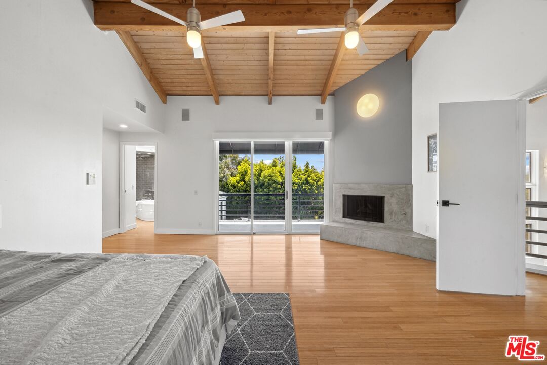 23400 West Moon Shadows Drive Malibu, CA 90265 - Photo 16 of 31 a bedroom with a bed and a fireplace