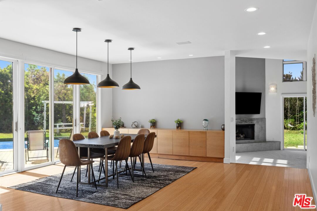 23400 West Moon Shadows Drive Malibu, CA 90265 - Photo 4 of 31 a dining room with furniture window and wooden floor