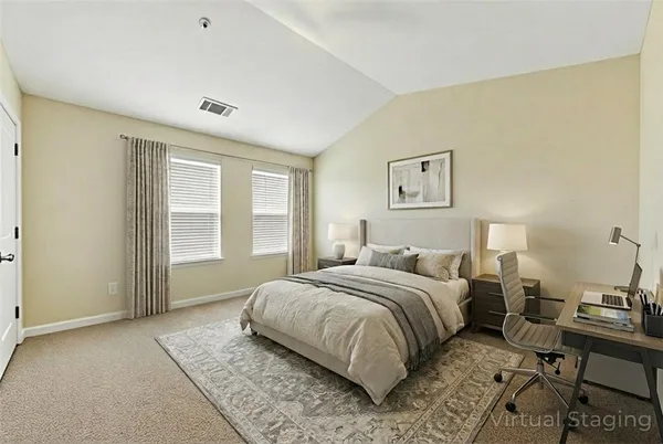 a bedroom with a bed and a desk