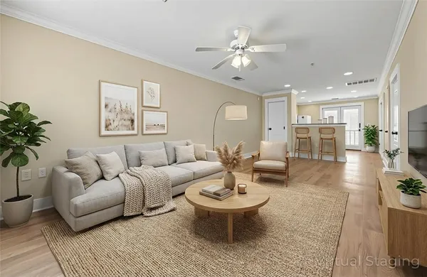 a living room with furniture and a wooden floor
